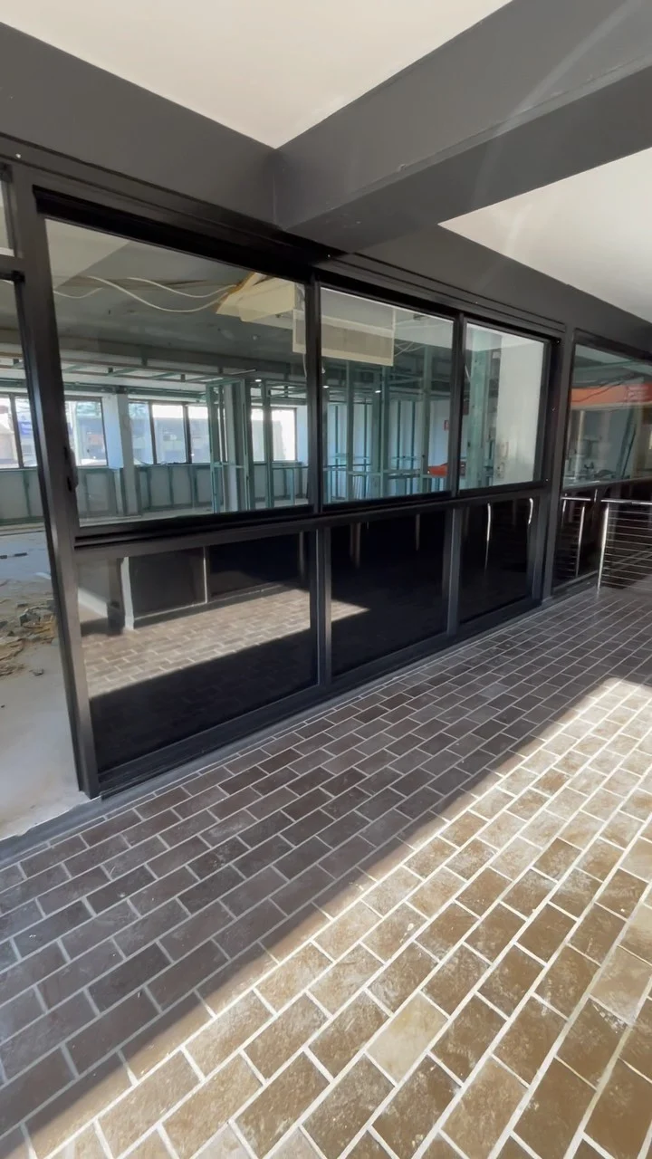 Black aluminium shopfront glazing installed by Tuggerah Lakes Glass during a Terrigal fitout